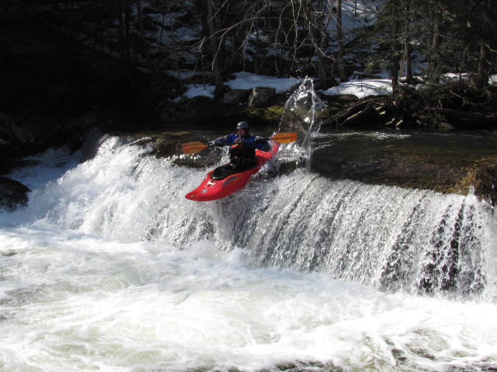 Jeff paddles over the small drop at the old dam on Rochester Creek.